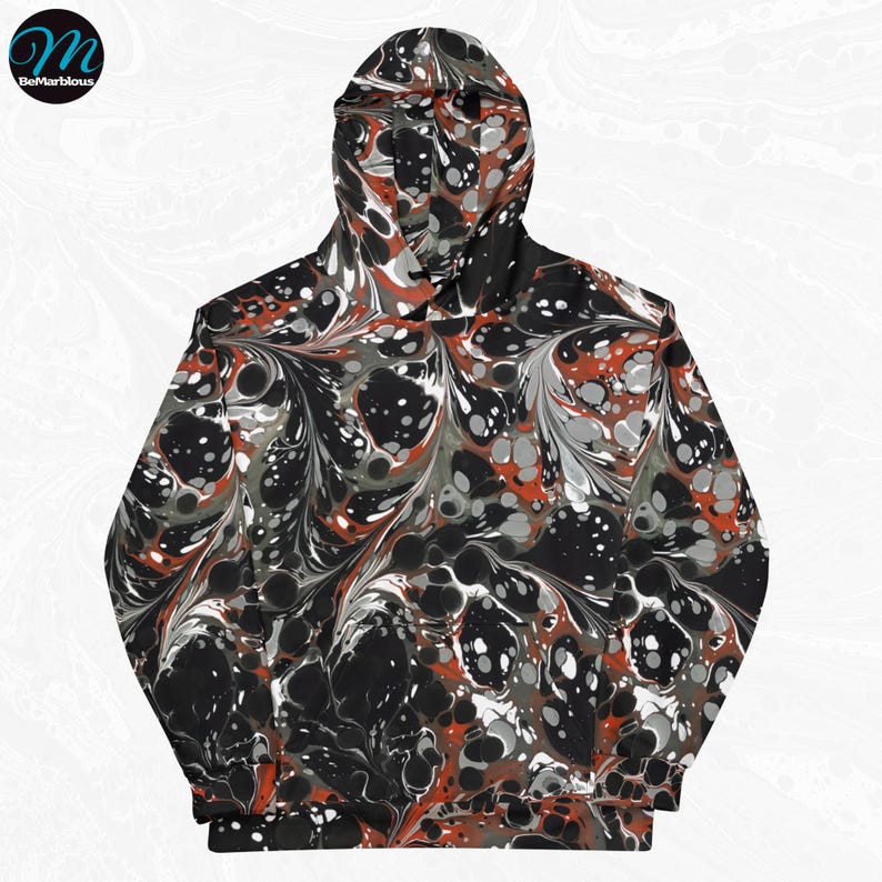May include: A black hoodie with a marbled pattern in shades of red, white, and gray. The pattern resembles swirling paint.