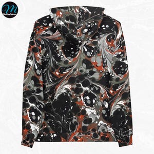 May include: A black hoodie with a red, white, and gray marbled pattern. The hoodie has a drawstring hood and a kangaroo pocket.