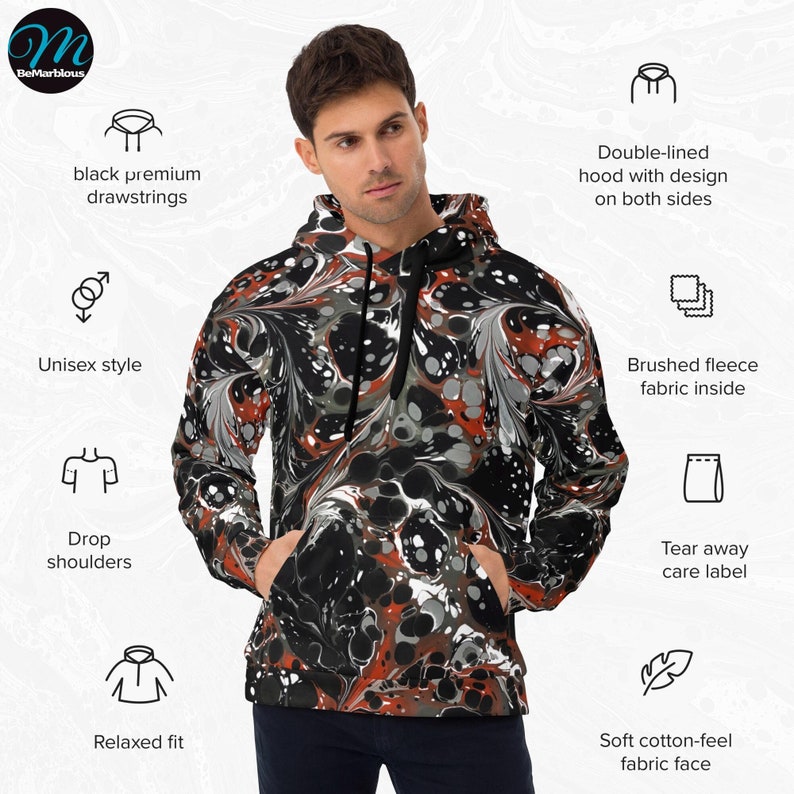 May include: A black and orange marbled hoodie with a relaxed fit and drop shoulders. The hoodie has a double-lined hood with a design on both sides, black premium drawstrings, and a brushed fleece fabric inside. The care label is tear away and the fabric face has a soft cotton feel.