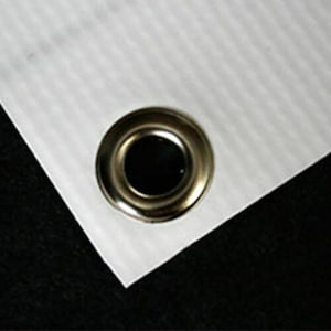 May include: Close-up of a white banner with a silver grommet.