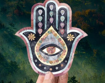 May include: A colorful hamsa hand with a galaxy eye in the center. The hamsa is a symbol of protection and good luck.