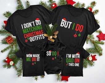 May include: A set of four black t-shirts with Christmas-themed text and graphics. The shirts say "I don't do matching Christmas outfits", "But I do", "Mom made me do it", and "I'm with dad on this one".