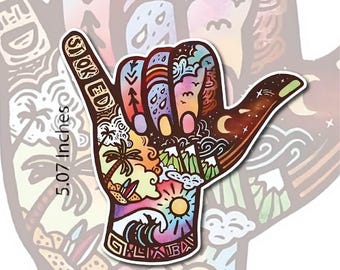 May include: A colorful sticker of a hand giving the shaka sign. The hand is decorated with a variety of patterns, including waves, stars, and flowers. The sticker is 6.07 inches wide and 5.07 inches tall. The sticker says "Stoked" on the index finger.