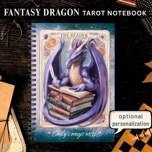 May include: A spiral-bound notebook titled FANTASY DRAGON TAROT NOTEBOOK featuring a purple dragon writing with a quill on a stack of books. The cover includes the text THE READER and Emily's magic notes, with a speech bubble stating optional personalization.