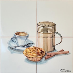 May include: Watercolor illustration on four square tiles. A cup of coffee, a pastry, a metal shaker, and cinnamon sticks are depicted. The artwork is signed "ATELIER FRANCISCO TANHA" in the bottom right corner.