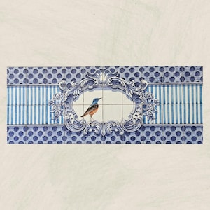 May include: A blue and white tile mural with a decorative frame and a blue bird inside. The tile pattern is a combination of hexagons and stripes.