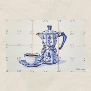 May include: A hand-painted illustration on ceramic tiles depicts a blue and white coffee maker and a cup of coffee. The coffee maker has a floral design. The cup sits on a saucer. The tiles have a repeating blue pattern.