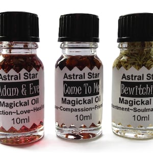 May include: Three small glass bottles with black caps and labels. Each bottle contains a clear liquid with herbs and flowers. The labels read "Astral Star Adam & Eve Magickal Oil Attraction~Love~Healing 10ml", "Astral Star Come To Me Magickal Oil Love~Compassion~Friendship 10ml", and "Astral Star Bewitching Magickal Oil Enchantment~Soulmate Attraction 10ml".