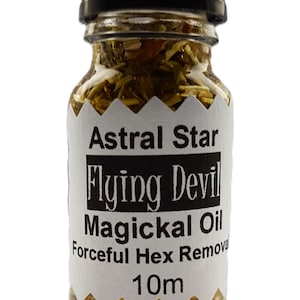 May include: A small glass bottle with a black cap filled with a yellow liquid and herbs. The label reads "Astral Star Flying Devil Magickal Oil Forceful Hex Removal 10ml".