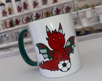 Red Welsh mischievous dragon with football