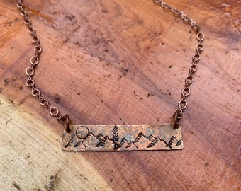 hand stamped mountain scene on artisan copper