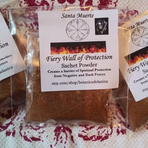 May include: A small clear plastic bag filled with brown powder. The bag has a label that says "Santa Muerte Fiery Wall of Protection Sachet Powder" and includes a symbol of a circle with a star in the center. The label also says "Creates a barrier of Spiritual Protection from Negative and Dark Forces" and includes a website address.