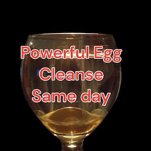 May include: A glass goblet filled with a yellow liquid. The text "Powerful Egg Cleanse Same day" is written in red on the glass.