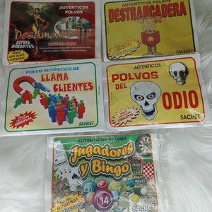 May include: Four colorful packets of powder with different labels. The packets are labeled "Desamarre", "Destrancadera", "Llama Clientes", and "Polvos del Odio". Each packet has a different image and text. The packets are all labeled "Sachet".