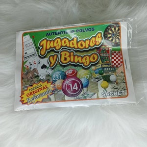 May include: A white and green packet with the text "AUTENTICOS POLVOS Jugadores y Bingo" and a picture of a bingo ball with the number 14. The packet also has the text "FORMULA ORIGINAL Reforzada" and "SACHET".
