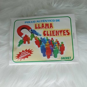 May include: A white box with a green border and the text "Polvo Aut&eacute;ntico de Llama Clientes" in red and black. The box features a red magnet attracting a group of colorful stick figures. The box also has a red starburst with the text "Polvo con color Original" and the word "Sachet" in the bottom right corner.