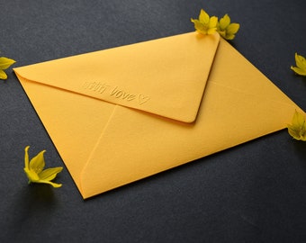 Yellow envelope with embossed "with love" lettering