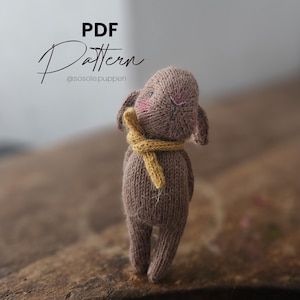 Knitting pattern for a rabbit (2 variations of the ear). Includes: dress and trousers.