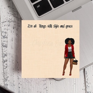 May include: A beige notepad with the text "Do all things with style and grace" and a digital illustration of a woman with dark skin wearing a red blazer, black shorts, and red heels.