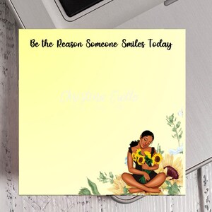 May include: A yellow background with the text "Be the Reason Someone Smiles Today" at the top. A woman with dark skin and long black hair is sitting with her legs crossed, holding a bouquet of sunflowers. The background is a yellow gradient with sunflowers and other flowers.