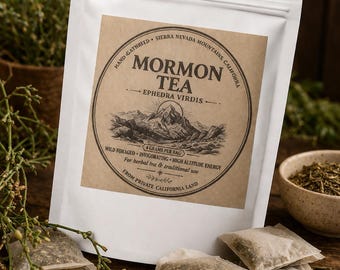 May include: A white resealable pouch containing Mormon Tea, Ephedra Virdis. The label features a mountain illustration and text: Hand Gathered, Sierra Nevada Mountains, California, 4 Grams Per Bag, Wild Foraged, Invigorating, High Altitude Energy.