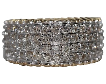 May include: A wide gold and silver band ring with multiple rows of small diamonds.