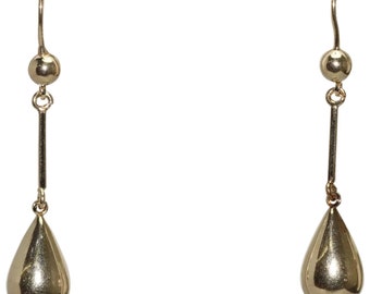 Pode incluir: Um par de brincos de ouro com um pingente em forma de lágrima e uma pequena bola no topo.