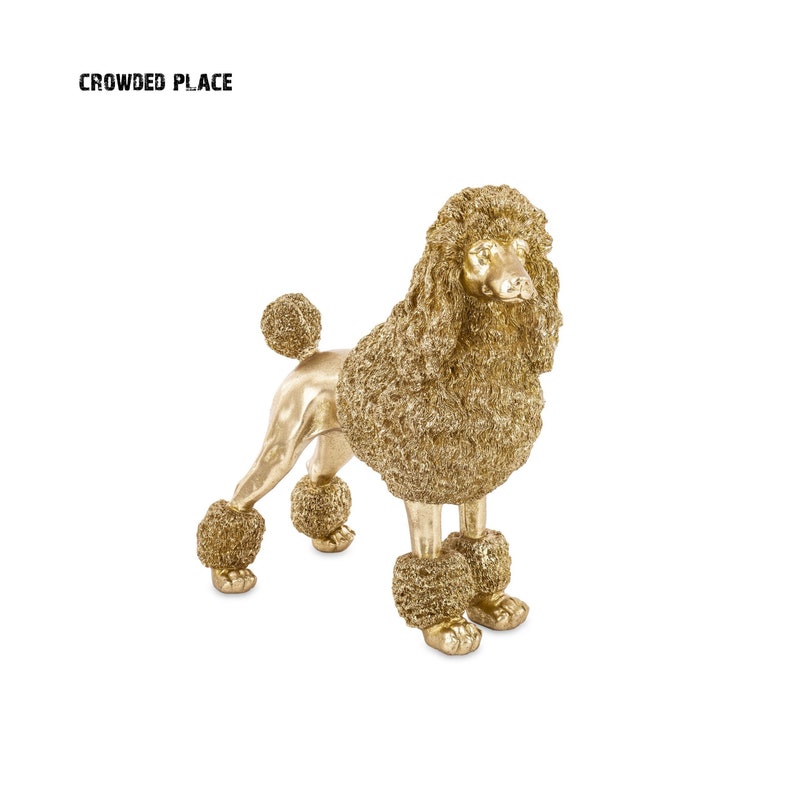 May include: A gold-colored poodle figurine with a fluffy, curly coat. The figurine is standing on a white background.