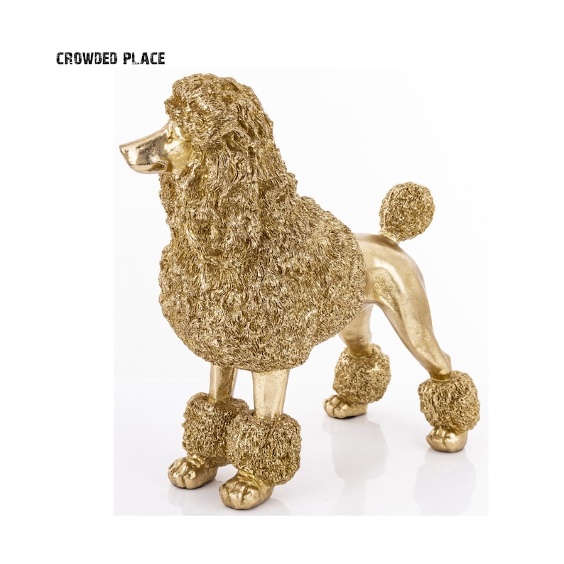 May include: A gold-colored poodle figurine with a fluffy, textured finish. The figurine is standing on a white surface.