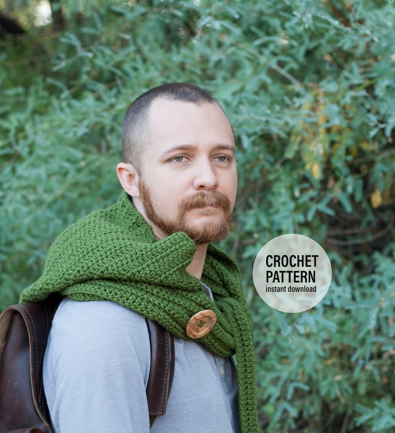 May include: A green crocheted scarf with a wooden button. The scarf is worn by a person with a beard and a gray shirt. The text "CROCHET PATTERN instant download" is on a white circle.