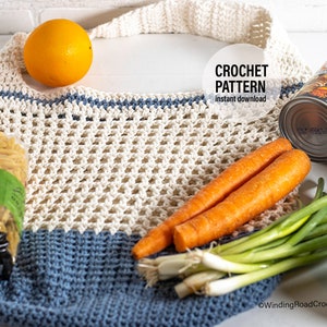 May include: A crocheted market bag in blue and white. The bag is filled with groceries, including an orange, carrots, spring onions, pasta, and a can of soup. The image also includes two balls of yarn, one blue and one white.