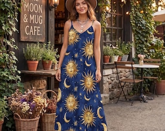 May include: A floor-length navy blue sleeveless dress featuring a repeating pattern of golden suns, crescent moons, and stars. The dress has thin spaghetti straps and a V-neckline. A wide-brimmed tan hat is worn with the dress.