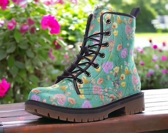 May include: Teal lace-up boots with a floral print featuring pink, yellow, and white flowers. The boots have a black rubber sole.