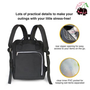 May include: Black diaper bag backpack with a zippered pocket on the front and a clear inner pocket. The bag has a rear zipper opening for easy access to items.