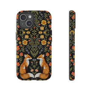 May include: Black phone case featuring a floral design with orange, yellow, and red flowers. Two foxes are facing each other at the bottom of the case. The side view shows the floral pattern continuing around the edges of the case.