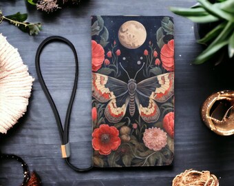 May include: A black leather wallet featuring a colourful butterfly and floral design. The butterfly has red, white and black wings. The flowers are red, pink and white. The background is a dark blue with a full moon and stars.