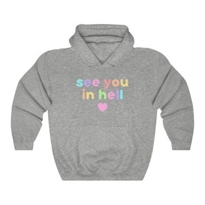May include: A grey hoodie with a rainbow coloured graphic that says "see you in hell" with a pink heart.