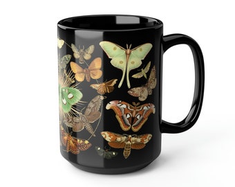 May include: Black coffee mug with a colorful pattern of various butterflies and moths. The mug has a white handle.