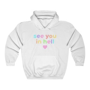 May include: White hoodie with a rainbow coloured graphic that says "see you in hell" with a pink heart below the text.