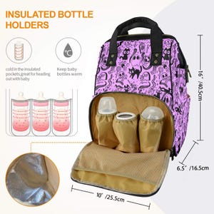 May include: A purple and black patterned diaper bag with insulated bottle holders. The bag has a large main compartment and a smaller front pocket. The bag is 16 inches tall, 10 inches wide, and 6.5 inches deep.