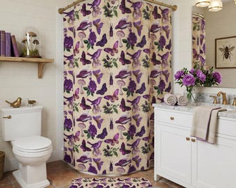 May include: A shower curtain and matching bath mat featuring a repeating pattern of purple butterflies, birds, mushrooms, and flowers on a cream background. The fabric items display a botanical and insect-themed print in shades of deep violet.