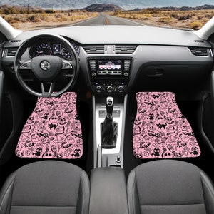 May include: Two pink car floor mats with a black and white pattern of ghosts, bats, cats, and other Halloween symbols.