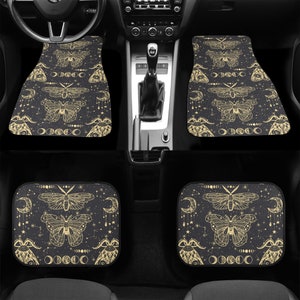 May include: Set of four black car floor mats with a gold and white pattern of moths, moons, and stars.