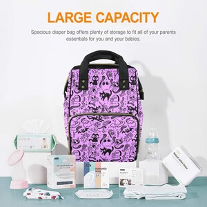 May include: A purple diaper bag with a black and white Halloween-themed print featuring ghosts, cats, and skulls. The bag has a large capacity and is perfect for carrying all of your baby's essentials.