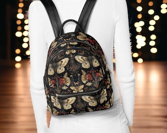 May include: A black leather backpack with a floral and butterfly print. The backpack has adjustable straps and a zip closure.