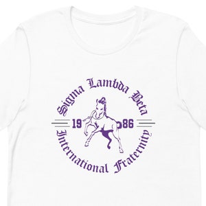 May include: White t-shirt with a purple circle graphic featuring a horse, the text "Sigma Lambda Beta", "1986", and "International Fraternity".