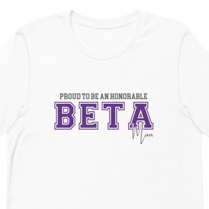 May include: White t-shirt with purple text that reads "Proud to be an honourable Beta Man".