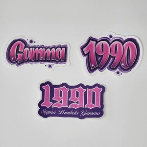 May include: Three stickers with a pink and purple gradient. One sticker says "Gamma" in a stylized font. The other two stickers say "1990" in a stylized font. One of the "1990" stickers also says "Sigma Lambda Gamma" below the number.