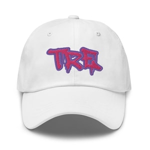 May include: White baseball cap with a pink and purple embroidered "TRE" logo.