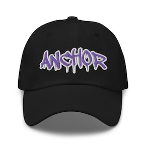 May include: A black baseball cap with a purple "ANCHOR" graphic embroidered on the front.